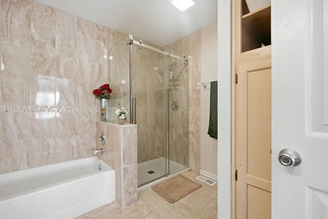 a bathroom with a shower and a tub