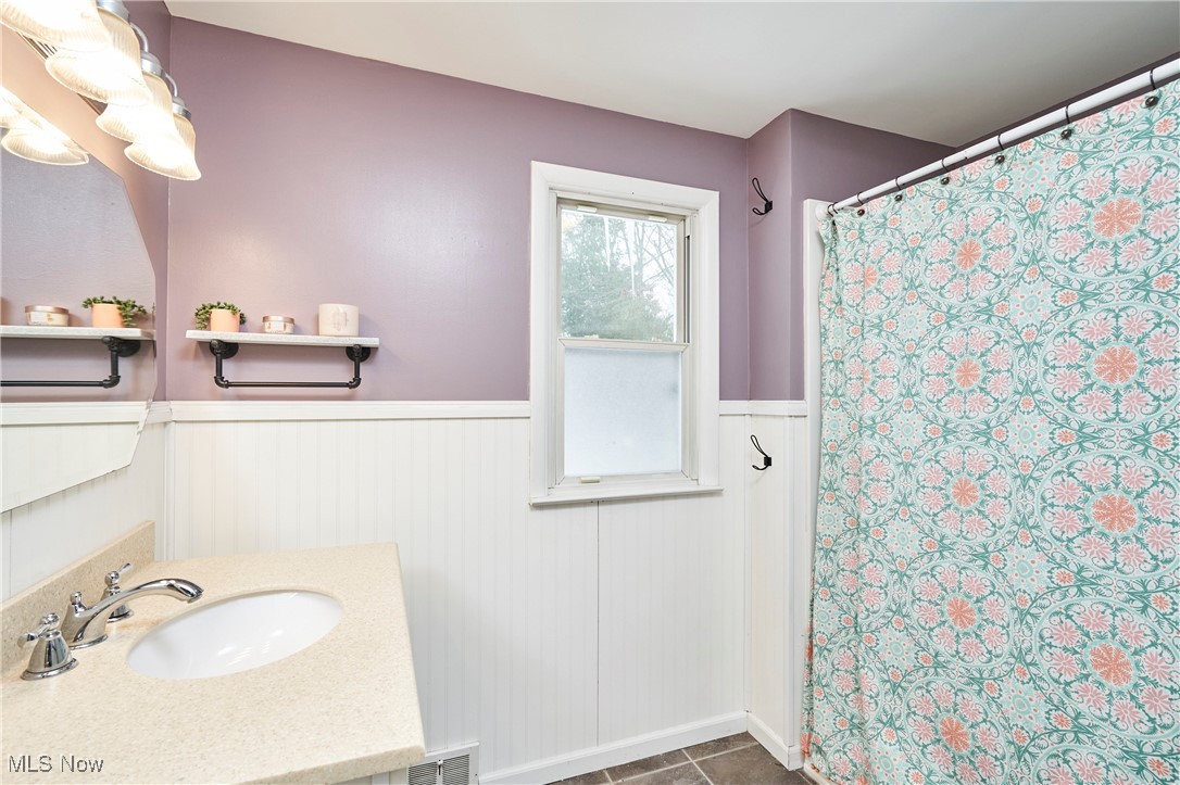 1847 Stabler Road Akron, OH 44313 - Photo 20 of 26 Bathroom featuring curtained shower, tile patterned flooring, and vanity