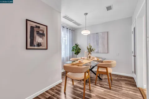 a view of a dining room with furniture and wooden floor