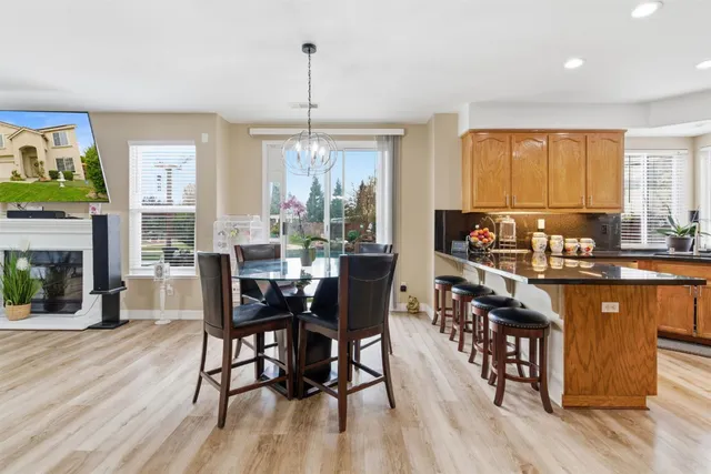 a kitchen with stainless steel appliances granite countertop a sink a stove and cabinets