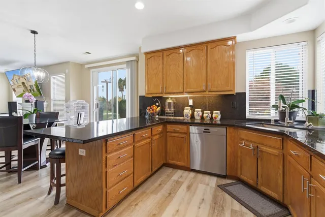 a kitchen with stainless steel appliances granite countertop a refrigerator sink and cabinets