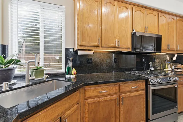 a view of a dining room and livingroom with furniture wooden floor a chandelier
