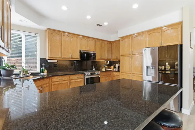 a living room with furniture a fireplace and a chandelier