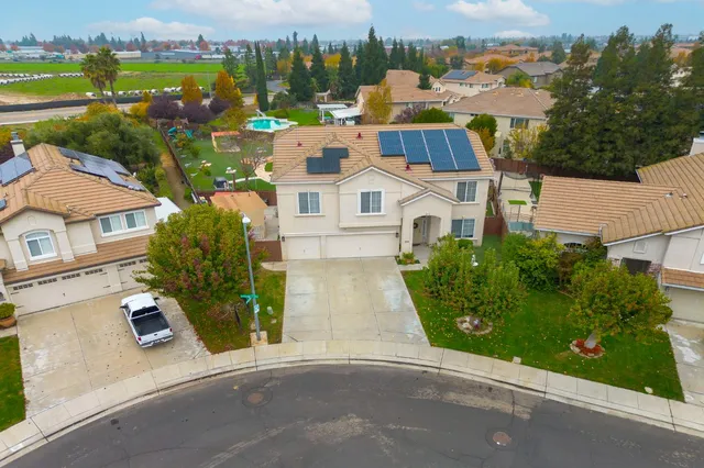 a view of a white house with a yard