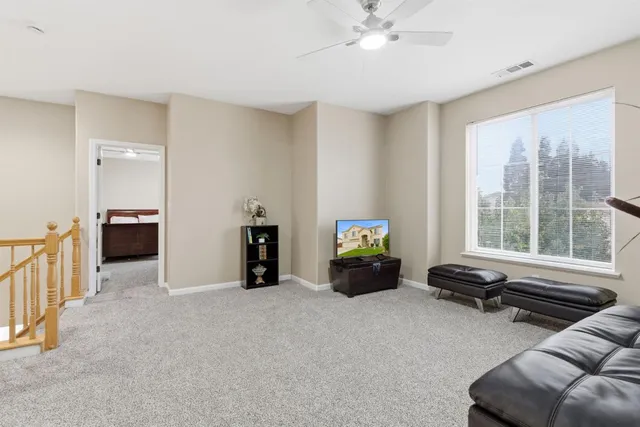 a bedroom with a large bed and a large window