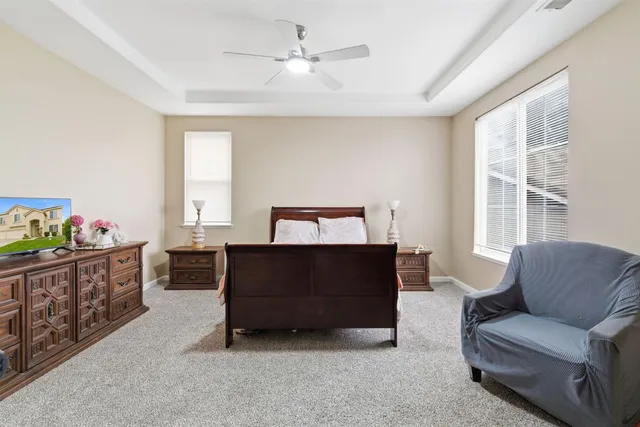 a bedroom with furniture and a flat screen tv