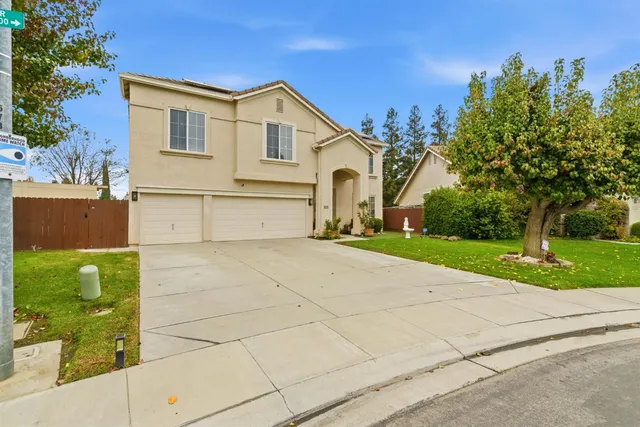 a view of backyard of house with outdoor seating and yard