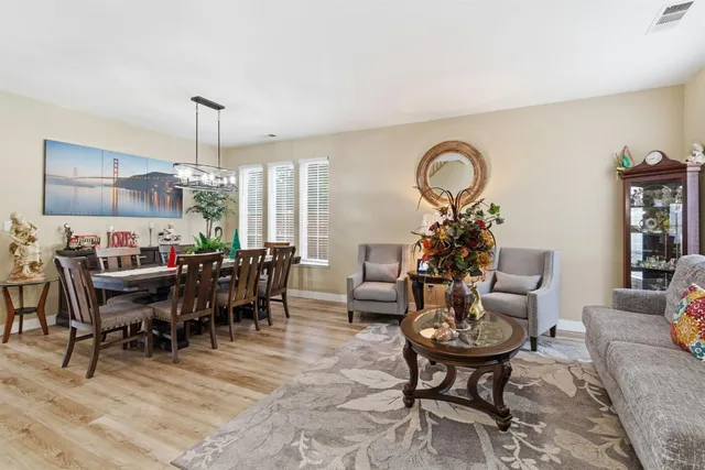 a view of a dining room with furniture window and wooden floor