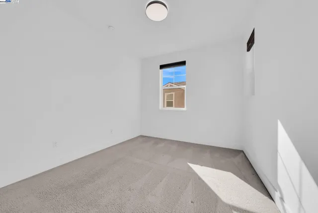 a view of an empty room with a kitchen