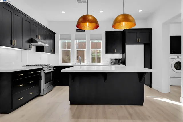 a kitchen with a stove and a microwave