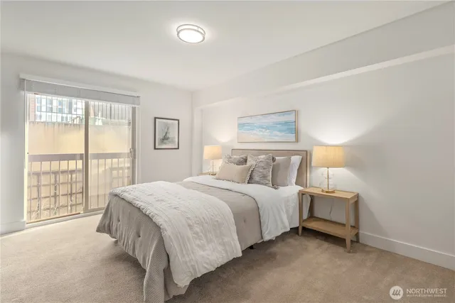 a bedroom with a bed and a night stand