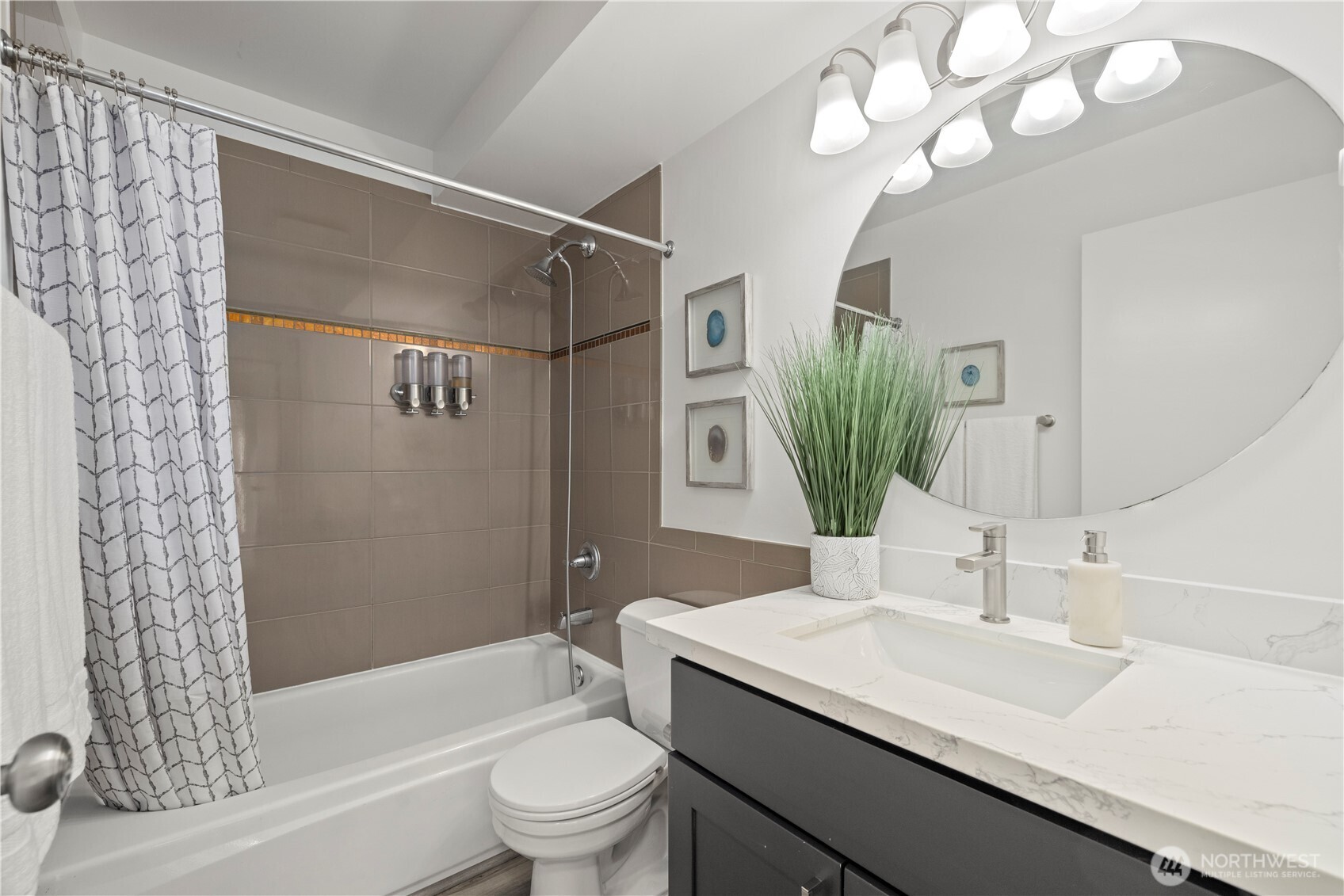 500 5th Avenue West, Unit 306 Seattle, WA 98119 - Photo 14 of 21 a bathroom with a sink a toilet a mirror a vanity and shower