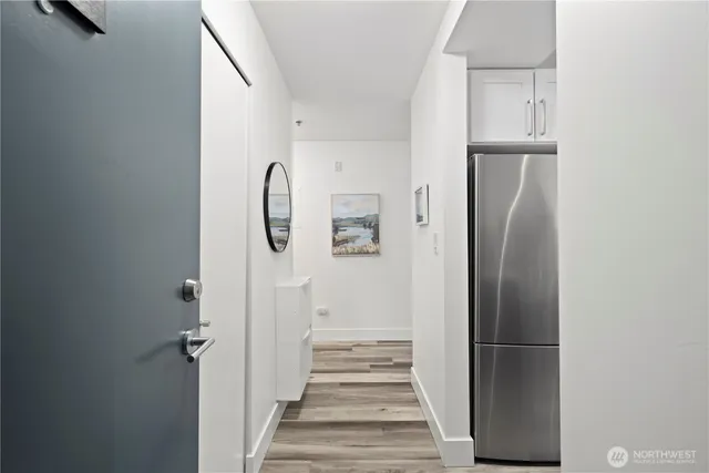 a view of a hallway with wooden floor and entryway