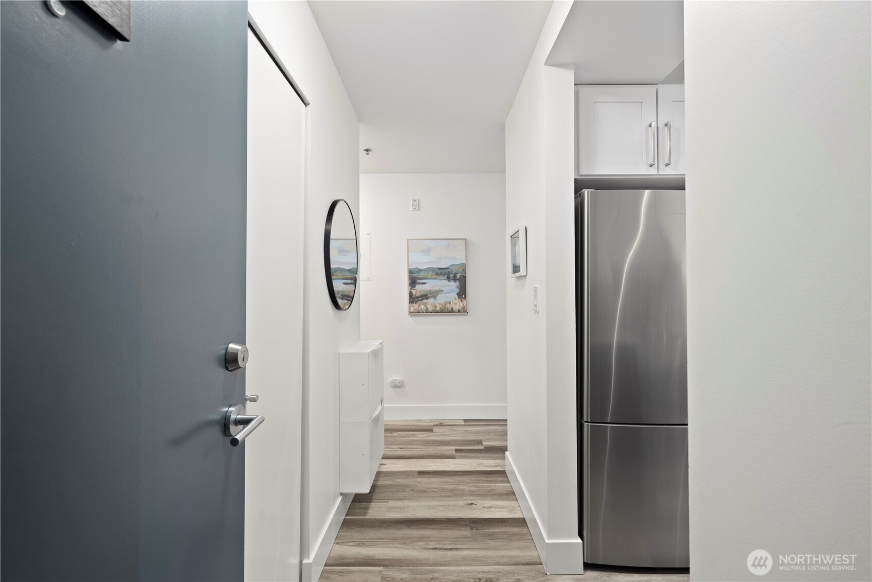 500 5th Avenue West, Unit 306 Seattle, WA 98119 - Photo 5 of 21 a view of a hallway with wooden floor and entryway