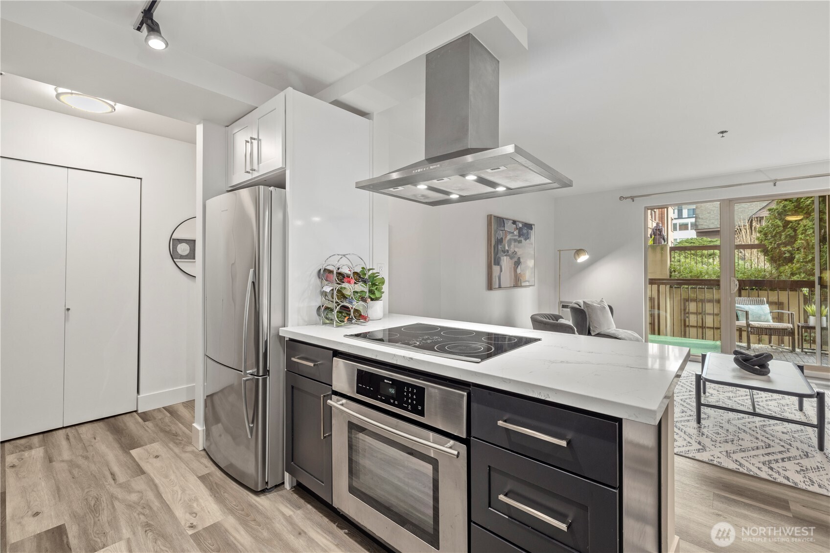 500 5th Avenue West, Unit 306 Seattle, WA 98119 - Photo 7 of 21 a kitchen with stainless steel appliances granite countertop a sink stove and refrigerator