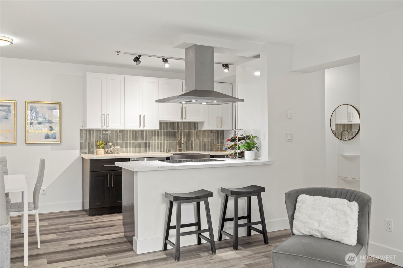 500 5th Avenue West, Unit 306 Seattle, WA 98119 - Photo 8 of 21 a kitchen with kitchen island granite countertop a table and chairs in it