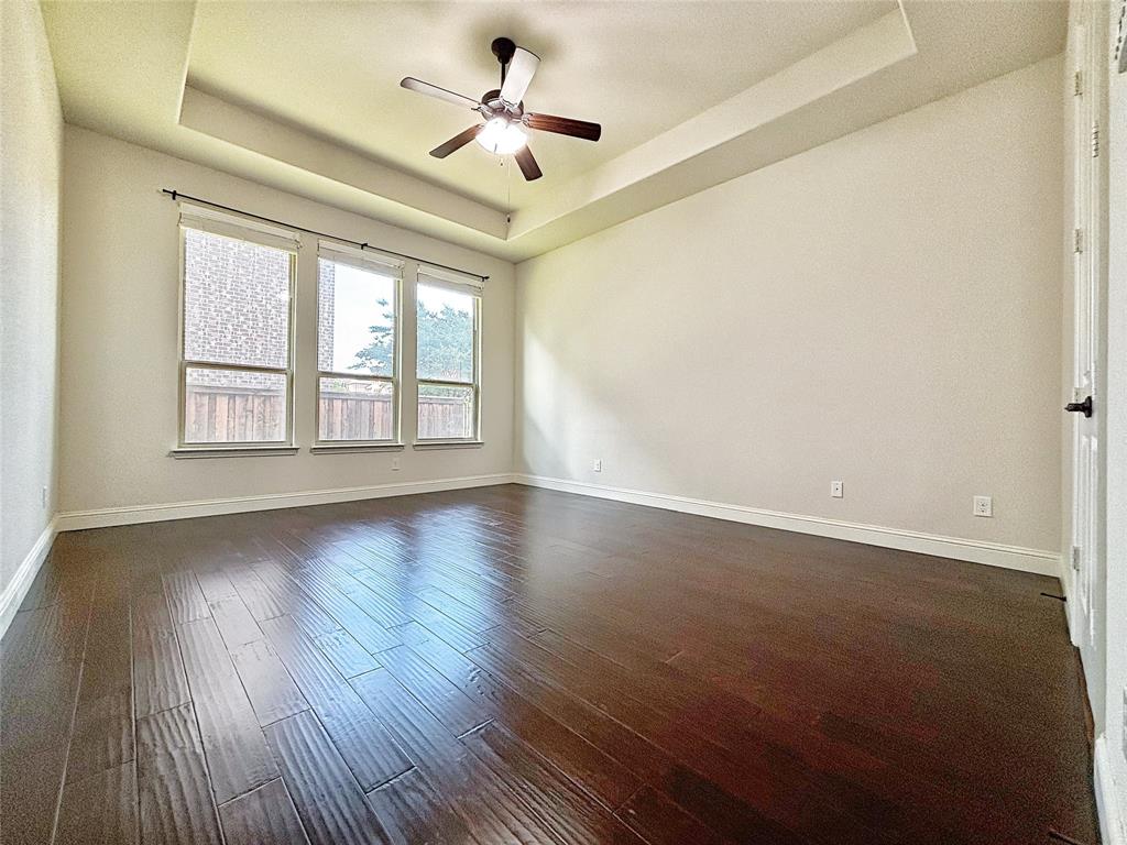 3037 Crestwater Ridge Keller, TX 76248 - Photo 14 of 25 a view of an empty room with wooden floor and a window