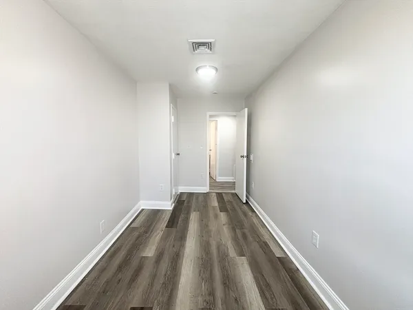 a view of hallway with wooden floor