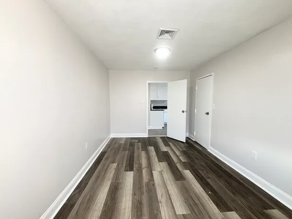 a view of wooden floor in an empty room