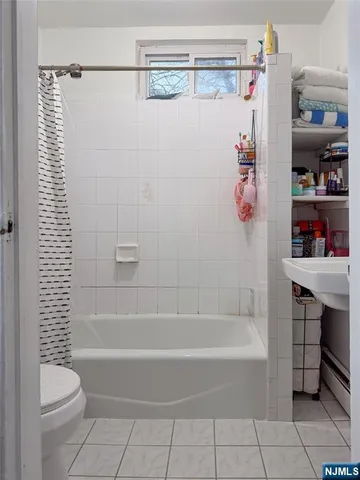 a bathroom with a bathtub sink and mirror
