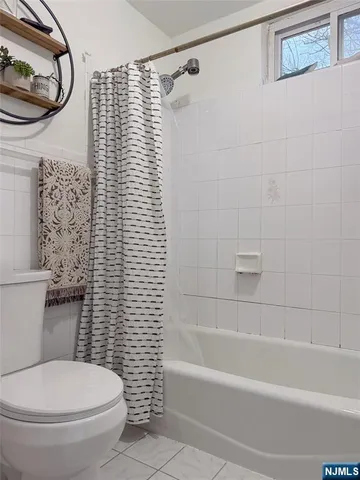 a front view of a residential apartment building with a yard