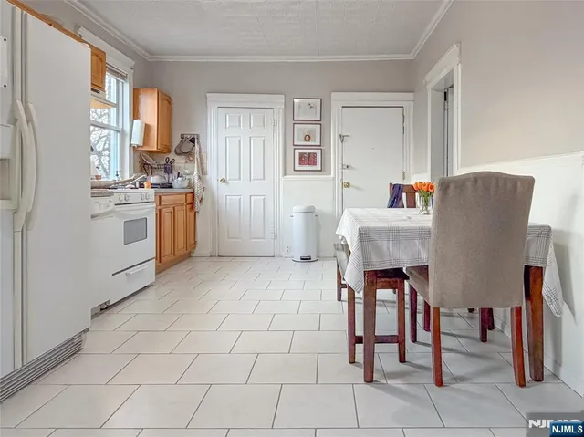 a kitchen with stainless steel appliances a refrigerator sink and cabinets