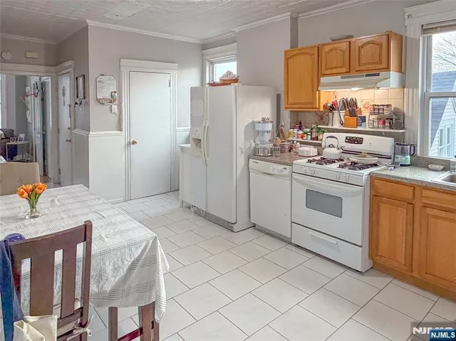 a kitchen with a sink stove and refrigerator