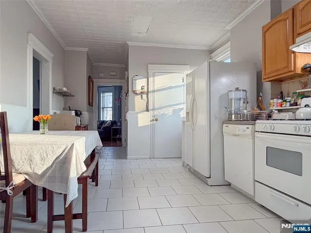 a hallway with a chair and dining table