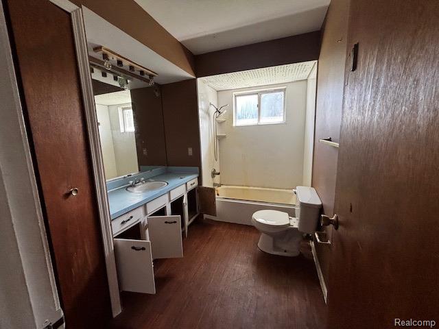 3901 West Lovejoy Road Byron, MI 48418 - Photo 11 of 19 Bathroom featuring shower / washtub combination, vanity, and dark wood-type flooring