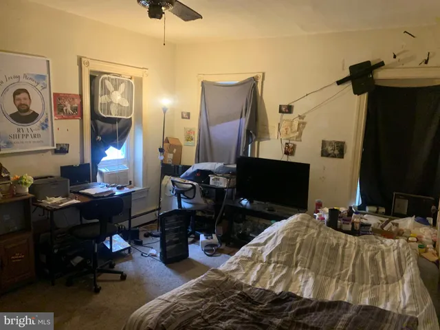 a bedroom with bed and a mirror