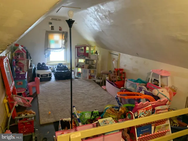 an outdoor living room with furniture and a flat screen tv