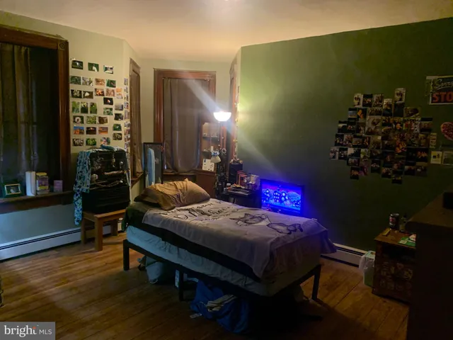 a bedroom with a bed table and a chair