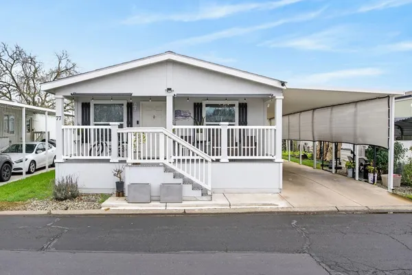 a view of a house with a wooden deck