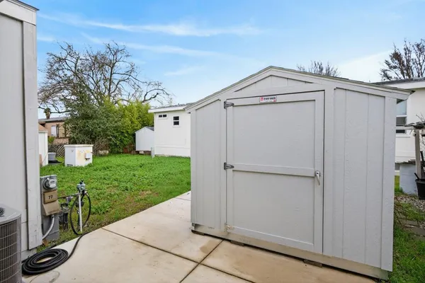 a view of a white house with a yard and garage