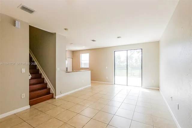 a view of an empty room with windows