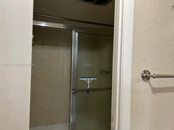 a bathroom with a glass shower door