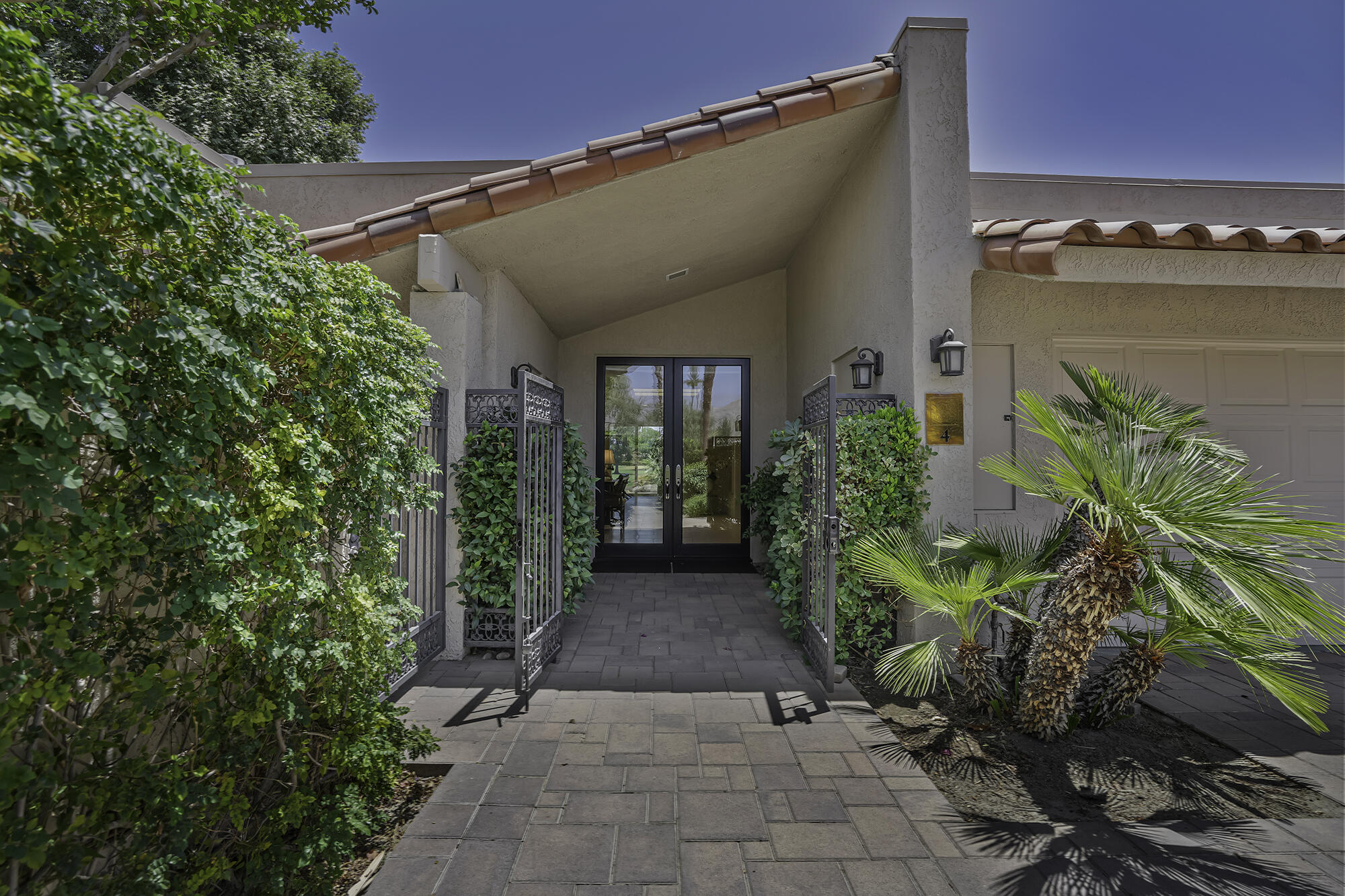 4 Stephens Court Rancho Mirage, CA 92270 - Photo 3 of 50 a view of a pathway both side of house