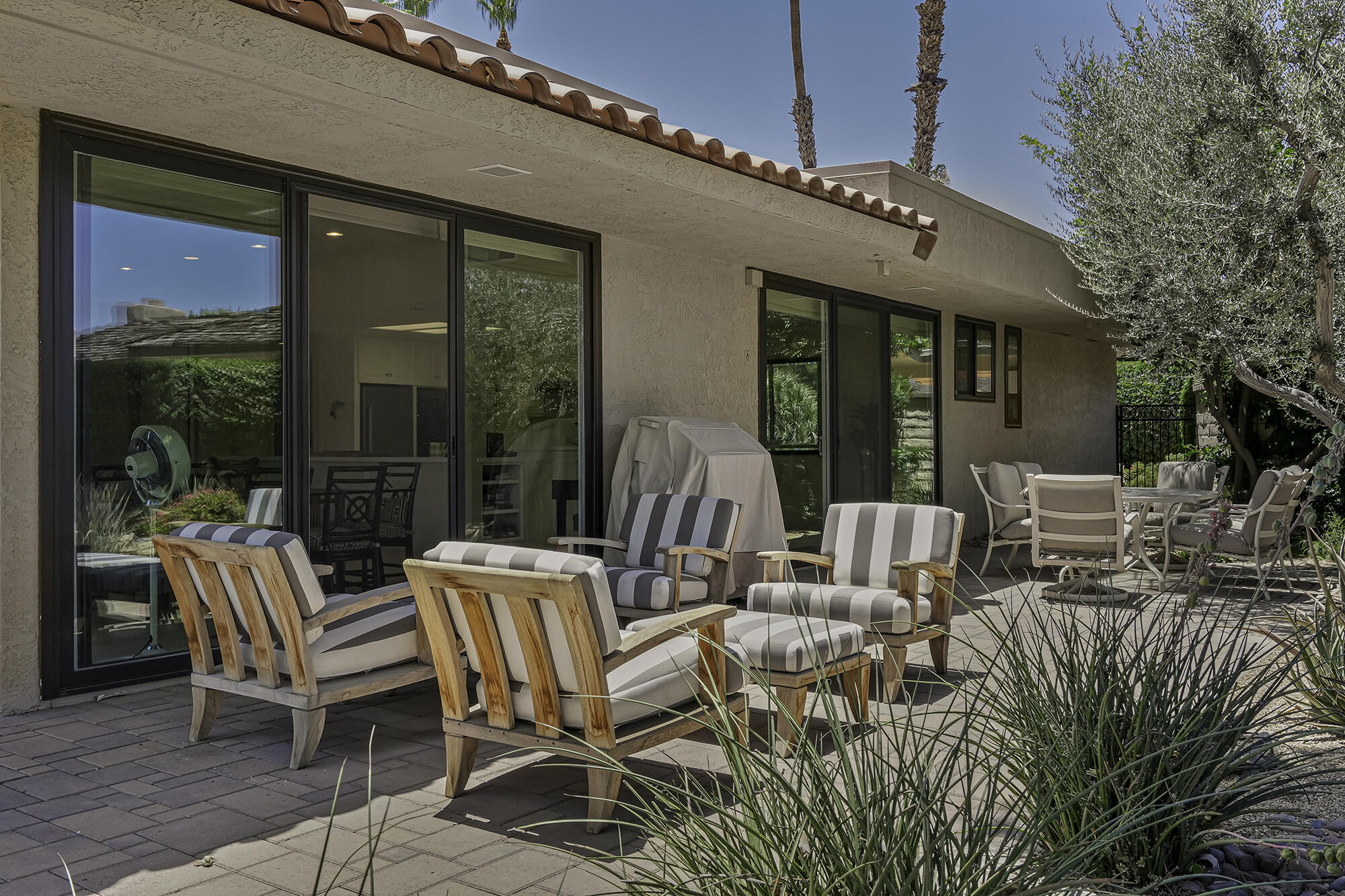 4 Stephens Court Rancho Mirage, CA 92270 - Photo 35 of 50 a view of a patio with table and chairs with wooden floor and fence