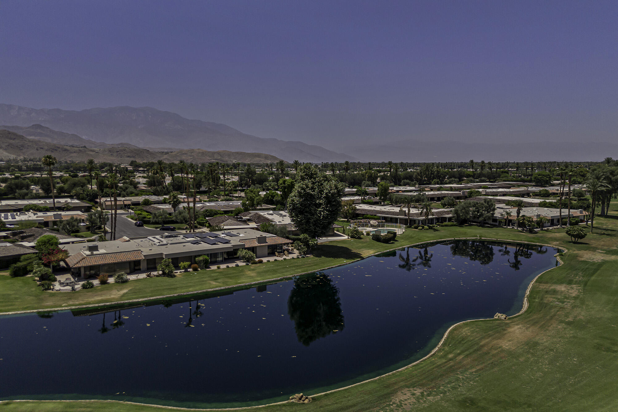 4 Stephens Court Rancho Mirage, CA 92270 - Photo 44 of 50 a view of a swimming pool with a table and chairs