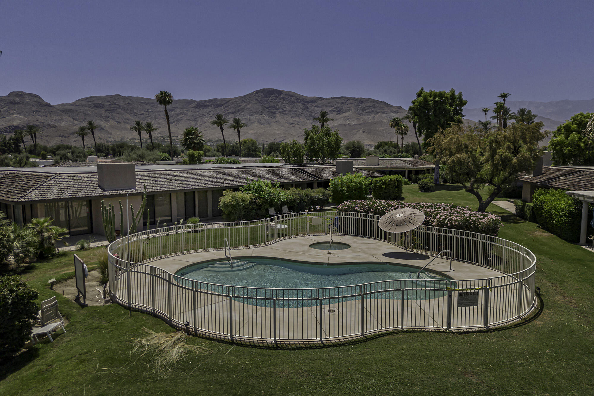 4 Stephens Court Rancho Mirage, CA 92270 - Photo 47 of 50 a view of a swimming pool with a patio and a garden