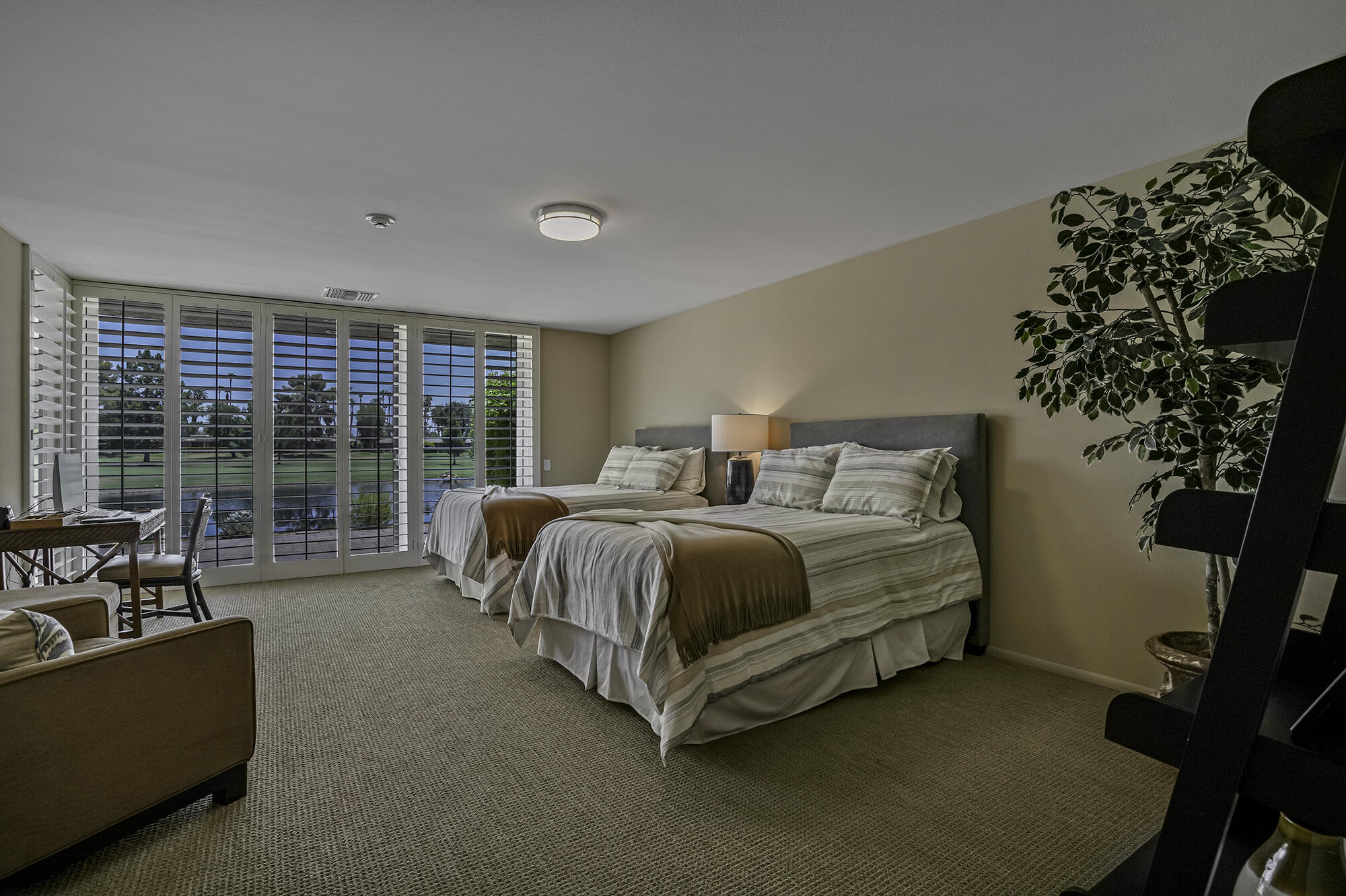 4 Stephens Court Rancho Mirage, CA 92270 - Photo 5 of 50 a spacious bedroom with a bed and a couch