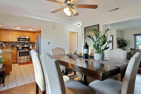 a kitchen with stainless steel appliances granite countertop a refrigerator and a stove top oven