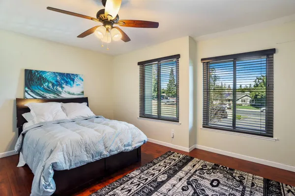 a bedroom with a large bed and a chandelier