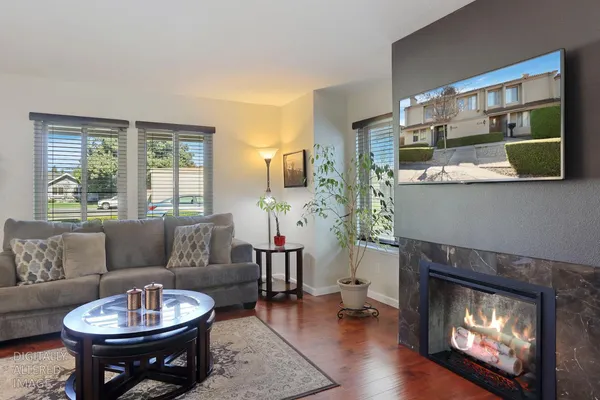 a living room with furniture and wooden floor