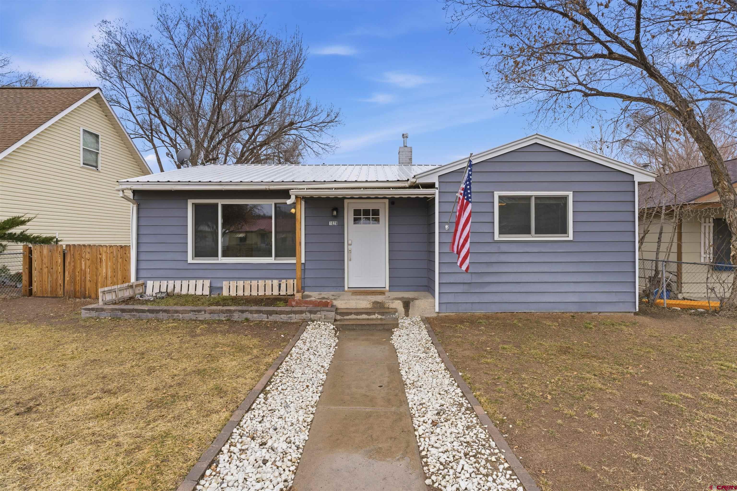 1029 Howard Street Delta, CO 81416 - Photo 17 of 17 a front view of a house with yard