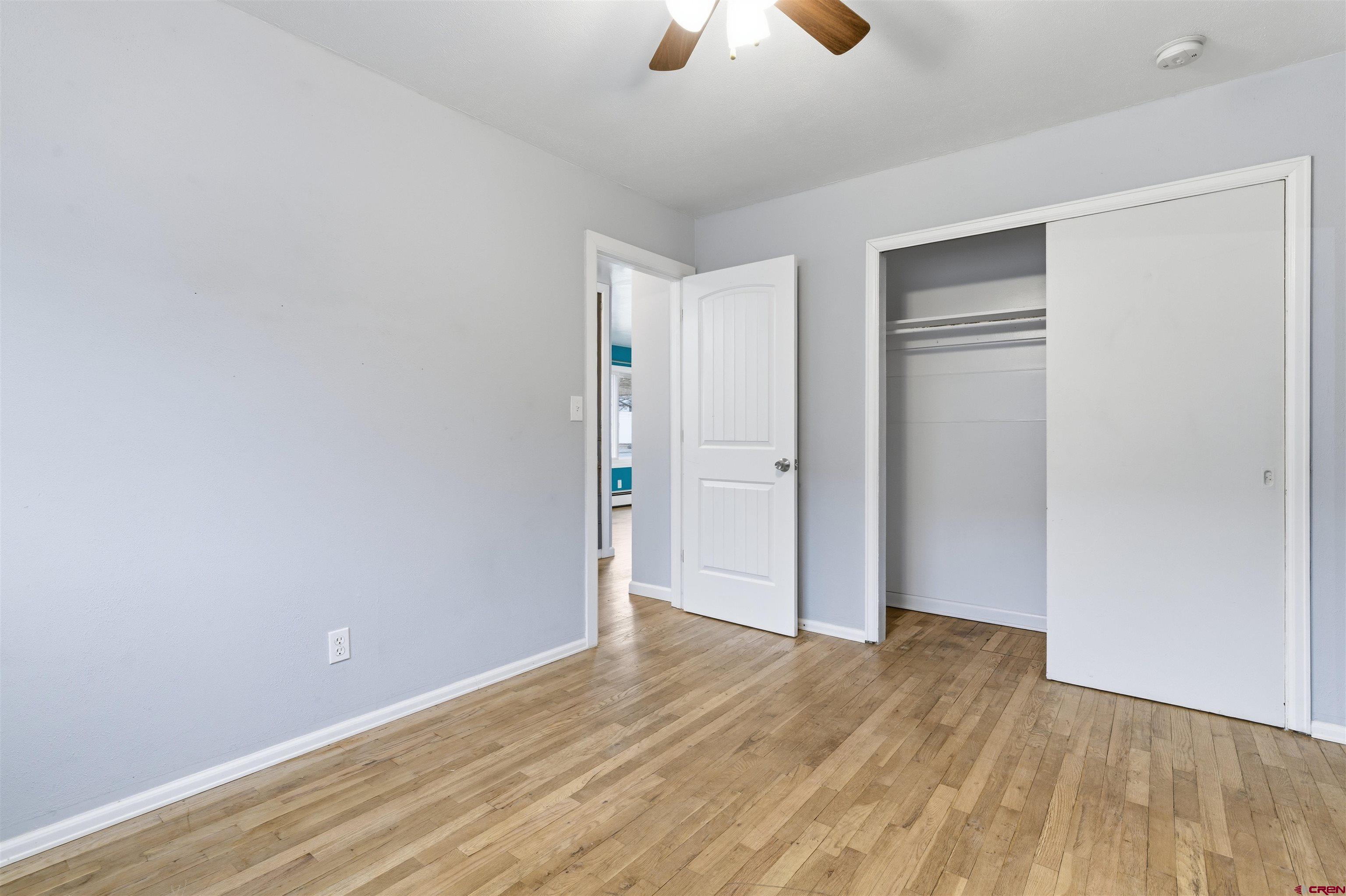 1029 Howard Street Delta, CO 81416 - Photo 10 of 17 a view of an empty room with wooden floor