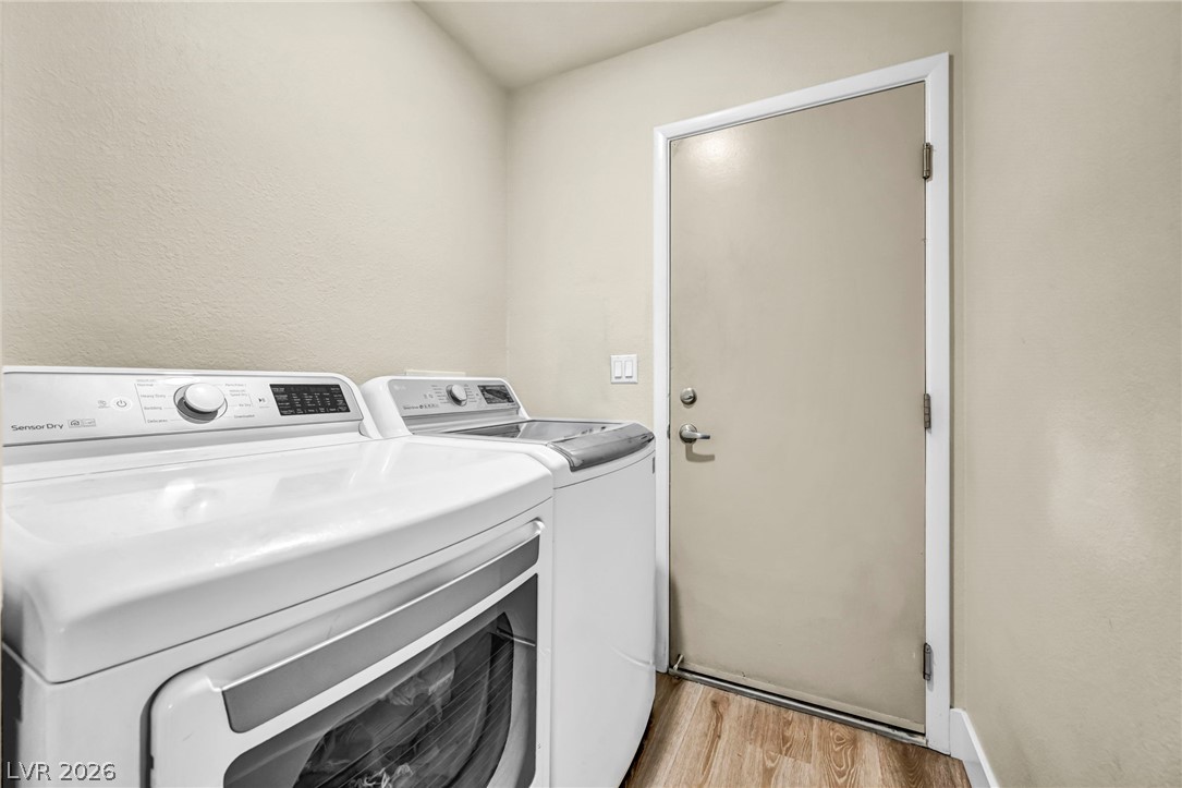 1234 Sunfire Street Henderson, NV 89014 - Photo 26 of 40 A well-appointed laundry room features modern appliances and durable flooring for daily tasks.