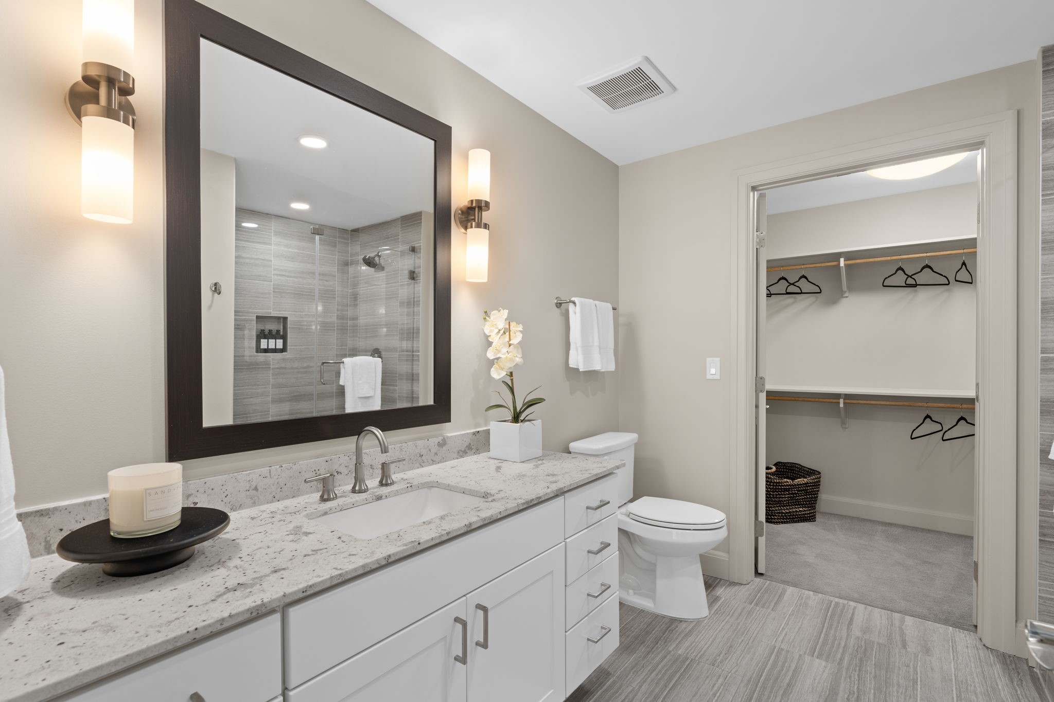 2511 Willowick Road, Unit 334 Houston, TX 77027 - Photo 16 of 39 a bathroom with a granite countertop sink a toilet and a mirror