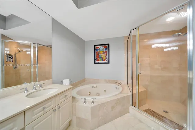 a bathroom with a tub sink and shower