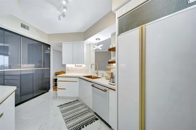 a kitchen with a sink appliances and cabinets